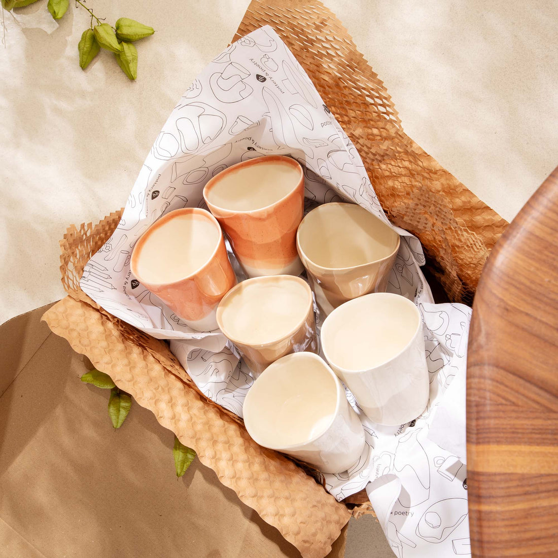 Six handmade ceramic cups in warm pastel colours in a gift box