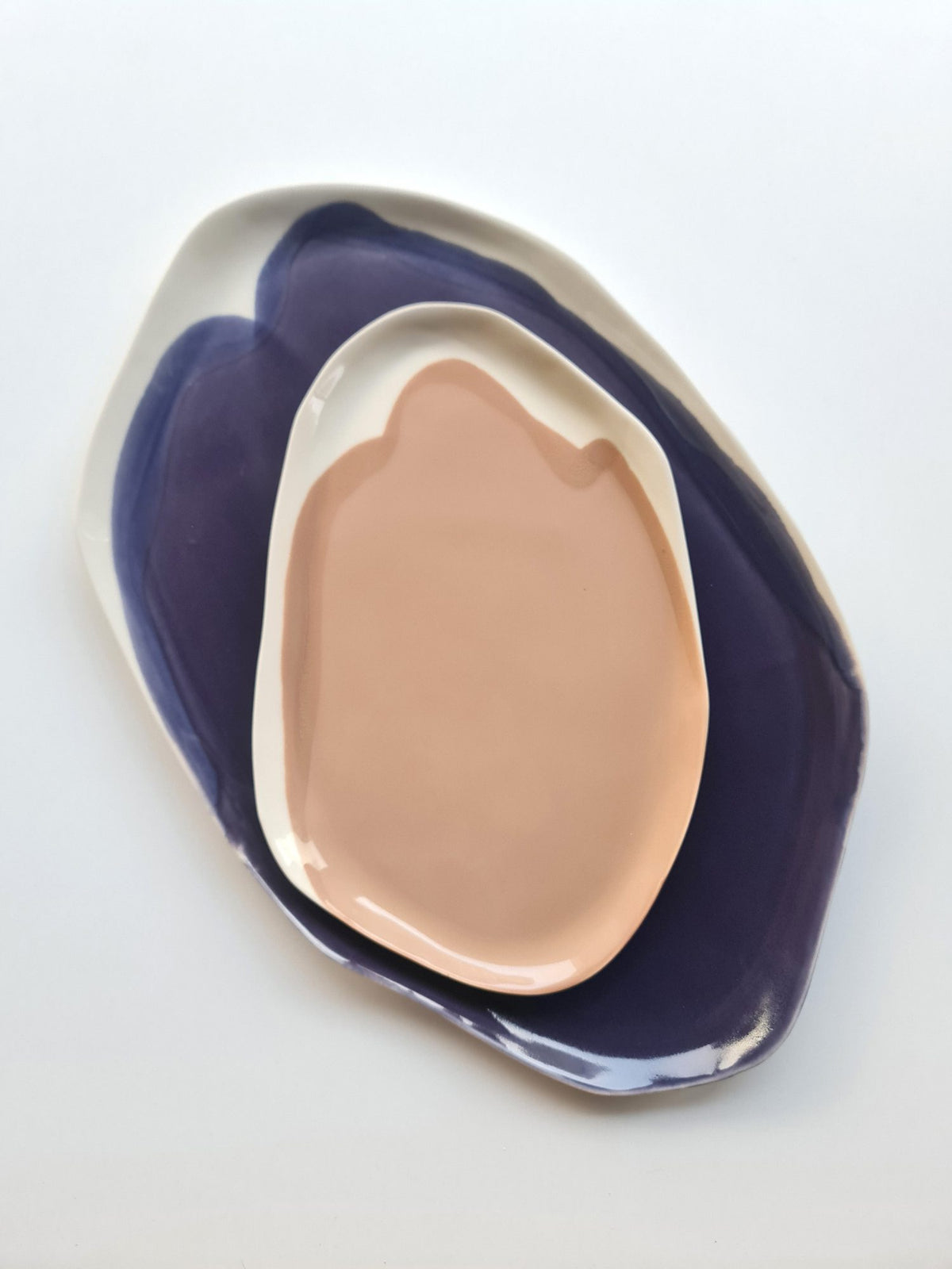 Signature serving tray set with a Mocha Mousse tray layered on a deep purple glazed tray