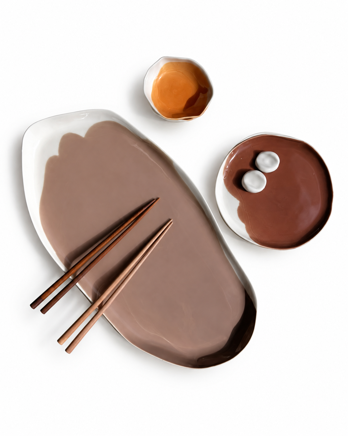 Brown-and-ivory ceramic platter with chopsticks beside a coordinating plate