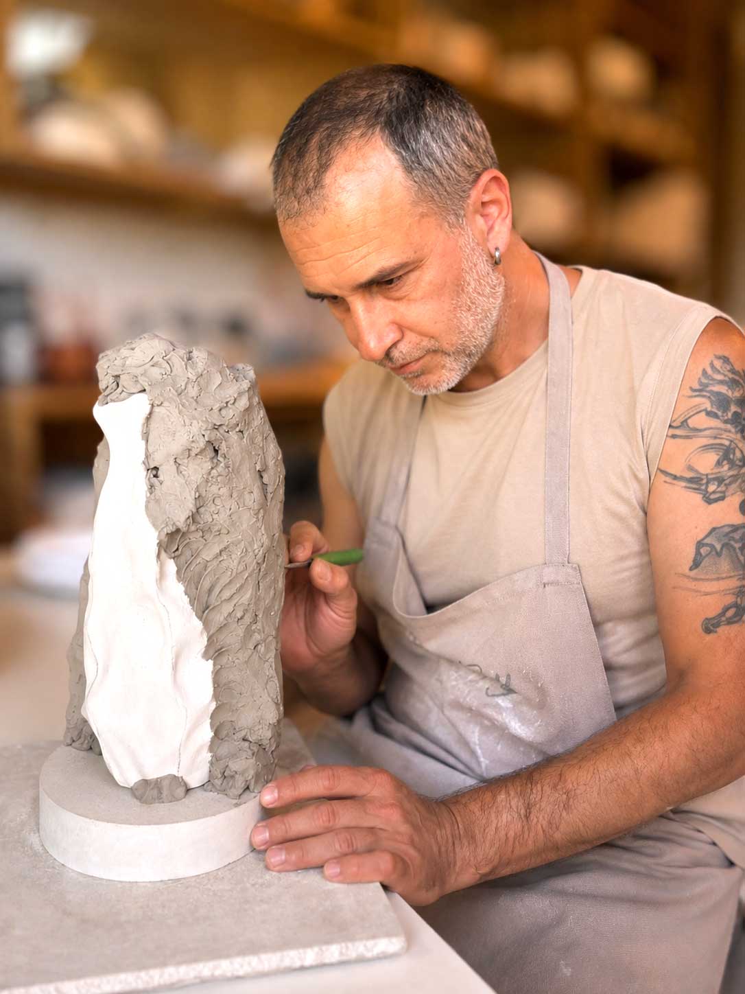 Martin Yonchevski, ceramicist at Pottery & Poetry, sculpting a clay piece in the Sofia studio