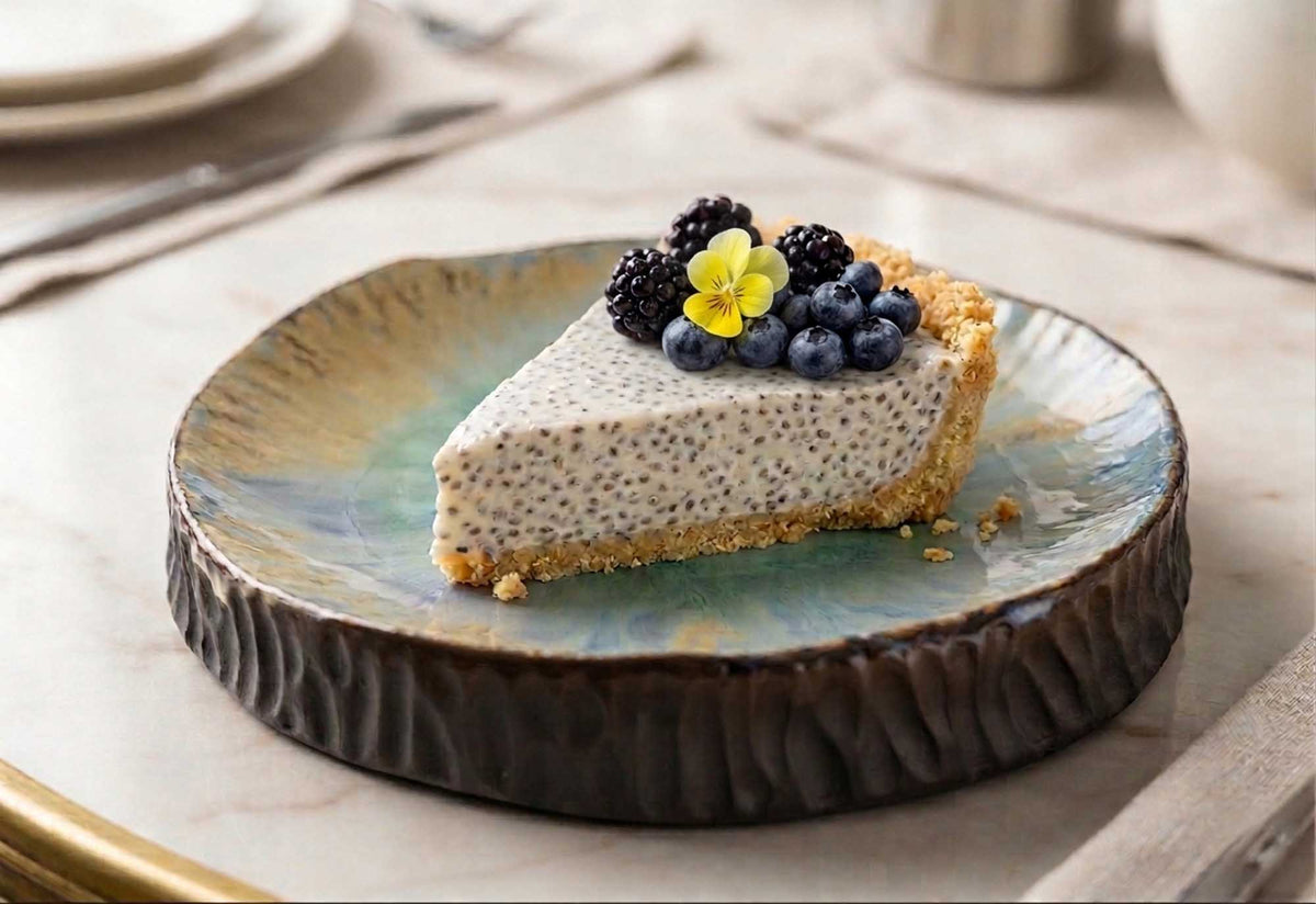 Slice of chia cheesecake with berries on a Textured Plate from Black Clay, fine dining style