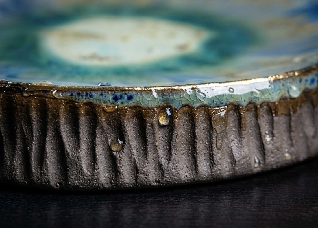 Close-up of the Textured Plate from Black Clay with ridged sides and a glossy blue glaze top