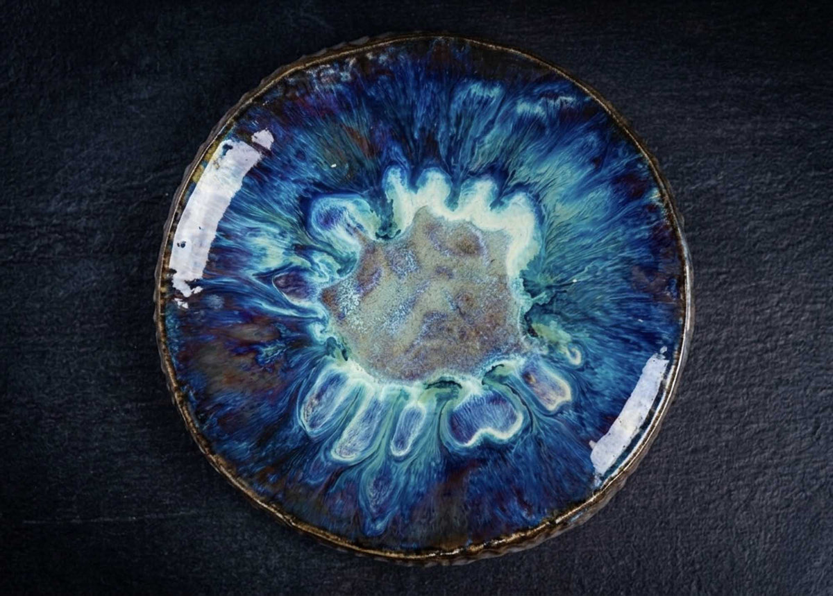 Textured plate from Black Clay with a reactive blue glaze, made by ceramicist Yasen Pisarov