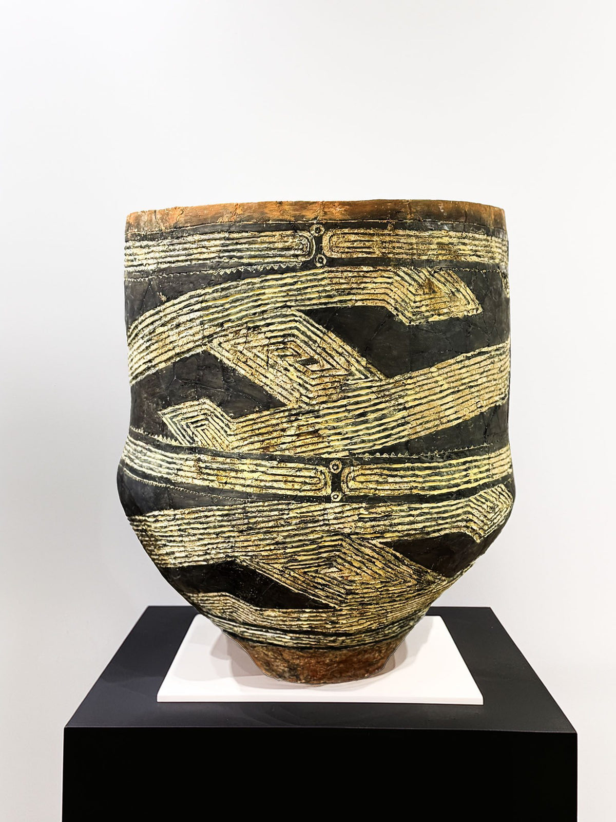Neolithic clay vessel with black and cream incised patterns, an ancestor of the sgraffito technique
