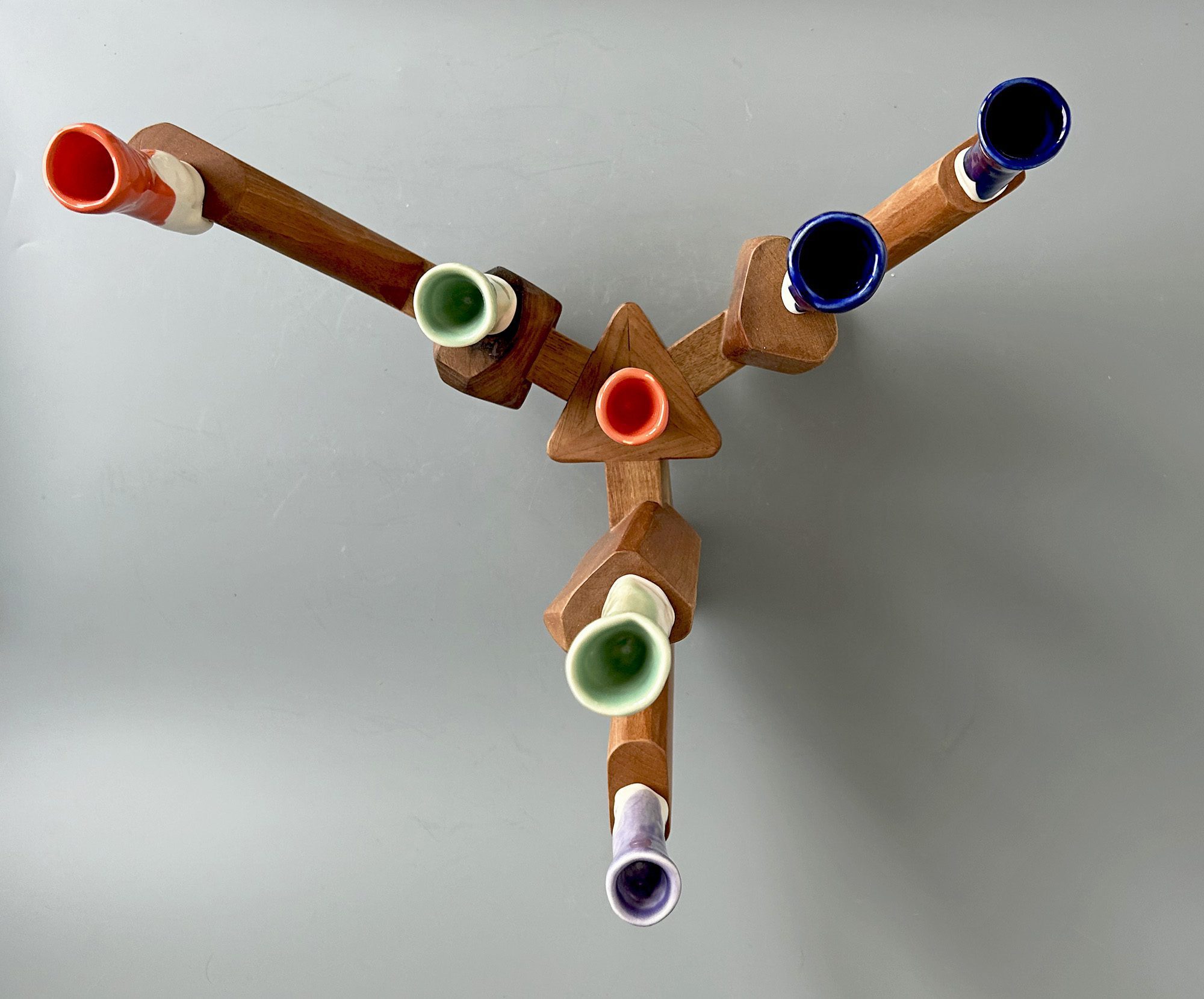 walnut wood and colorful porcelain candelabra