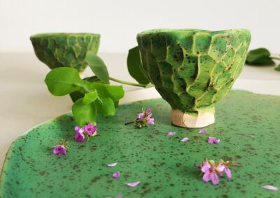 Porcelain cups with handles in soft, organic shapes.