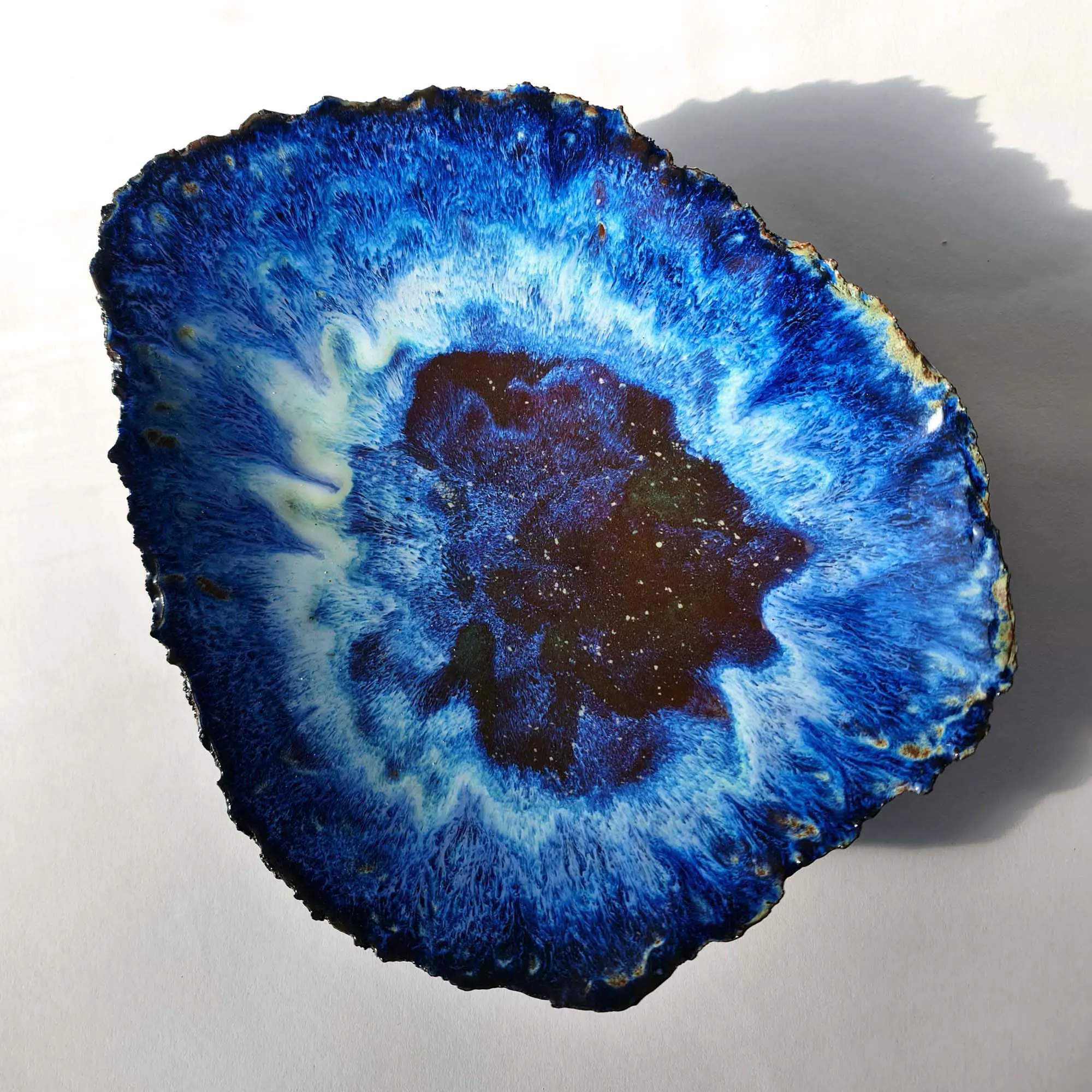 universe unique piece.jpg Sculptural bowl in black porcelain with layered blue floating glazes and textured exterior