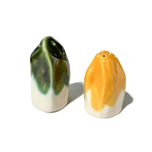 Sculptural salt and pepper shakers in green and yellow glaze on white porcelain
