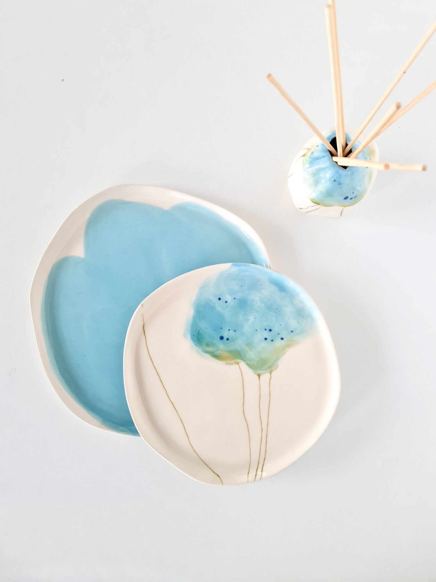 Handmade porcelain drinkware including cups and tumblers.
