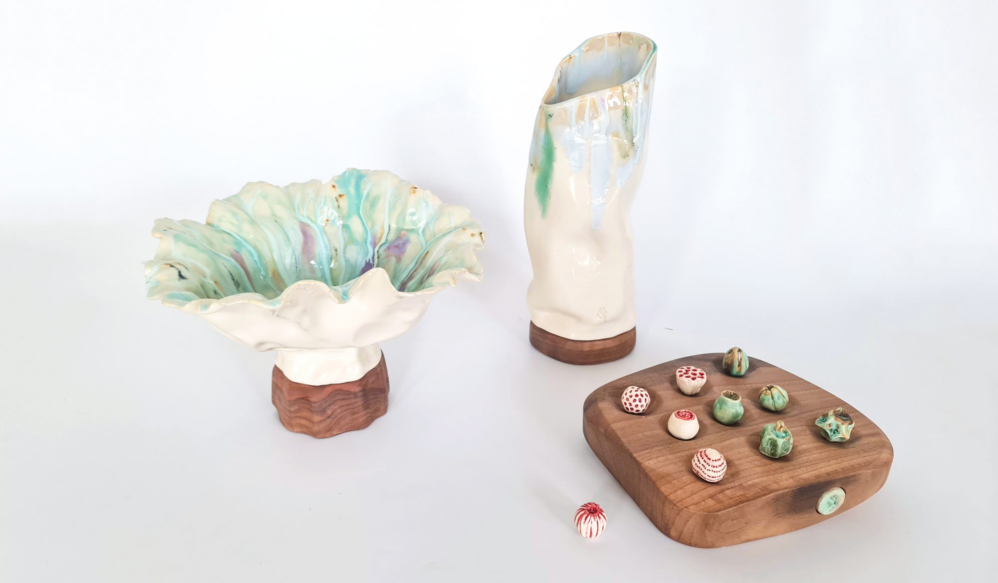 sea-reflections-items-and-Hue Porcelain fish plates with blue sgraffito designs, served with seafood dishes on a sunlit wooden table.