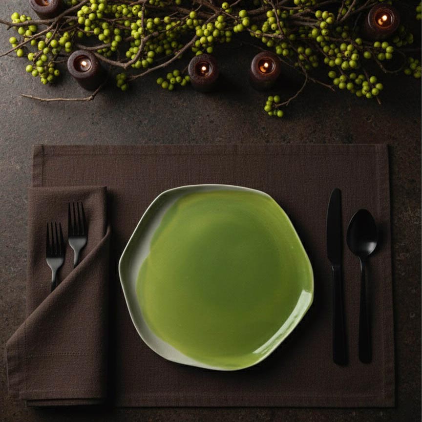 green plate on dark brown surface