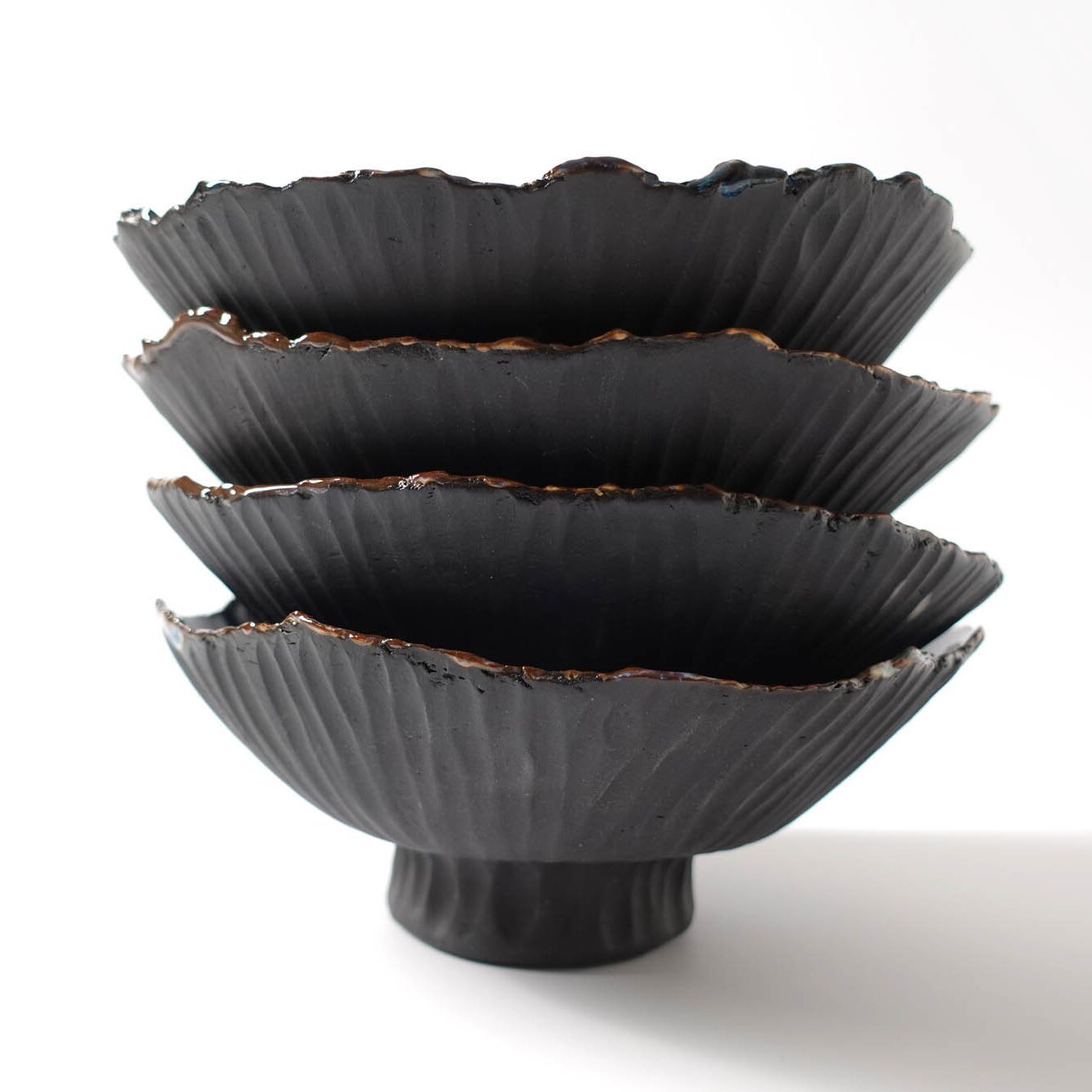 4 bowls stacked made from black porcelain and textured